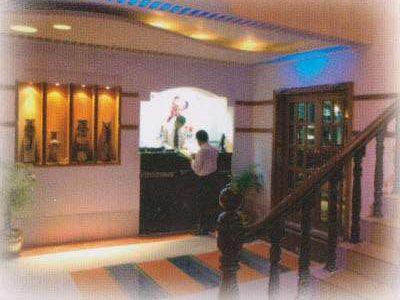 A lit display wall and wooden staircase inside the restaurant